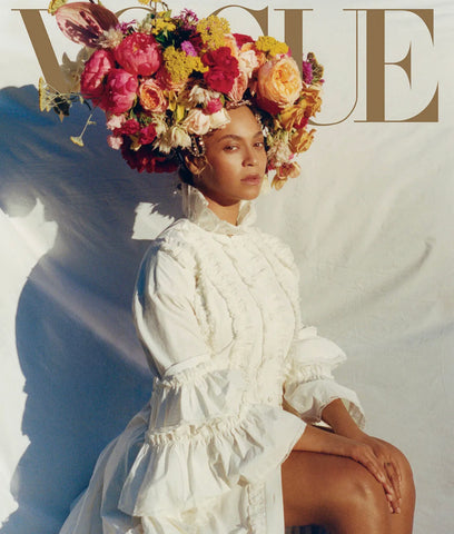 Beyonce wearing a crown of flowers on the cover of Vogue.