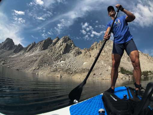 Man on iSUP paddling around the lake