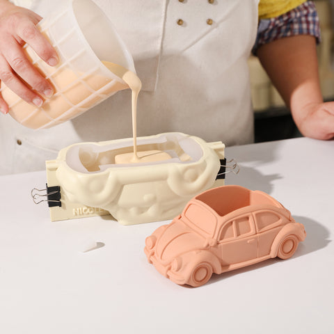 Demonstrating the use of a silicone mold set to make plant pots, with the finished plant pots placed next to them.