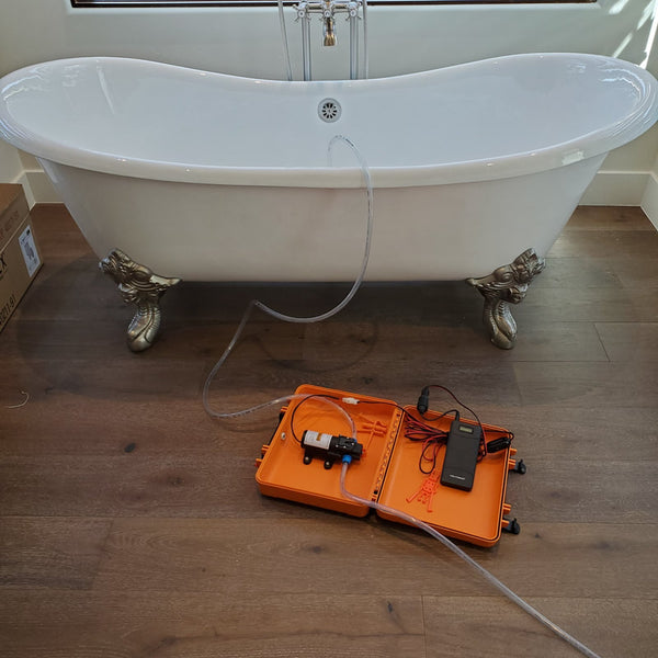 Drain bathtub with portable electric water pump