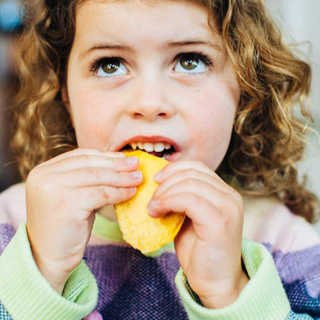 child eating mango