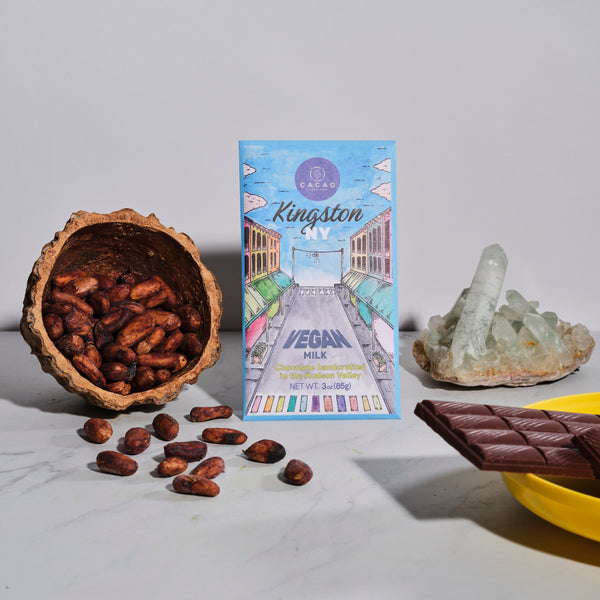 vegan milk chocolate bar with a crystal and cacao beans