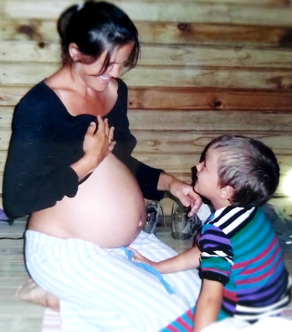 Pregnant woman with her son, smiling