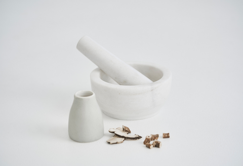 Chinese Medicine for acne herbal ingredients with mortar and pestle