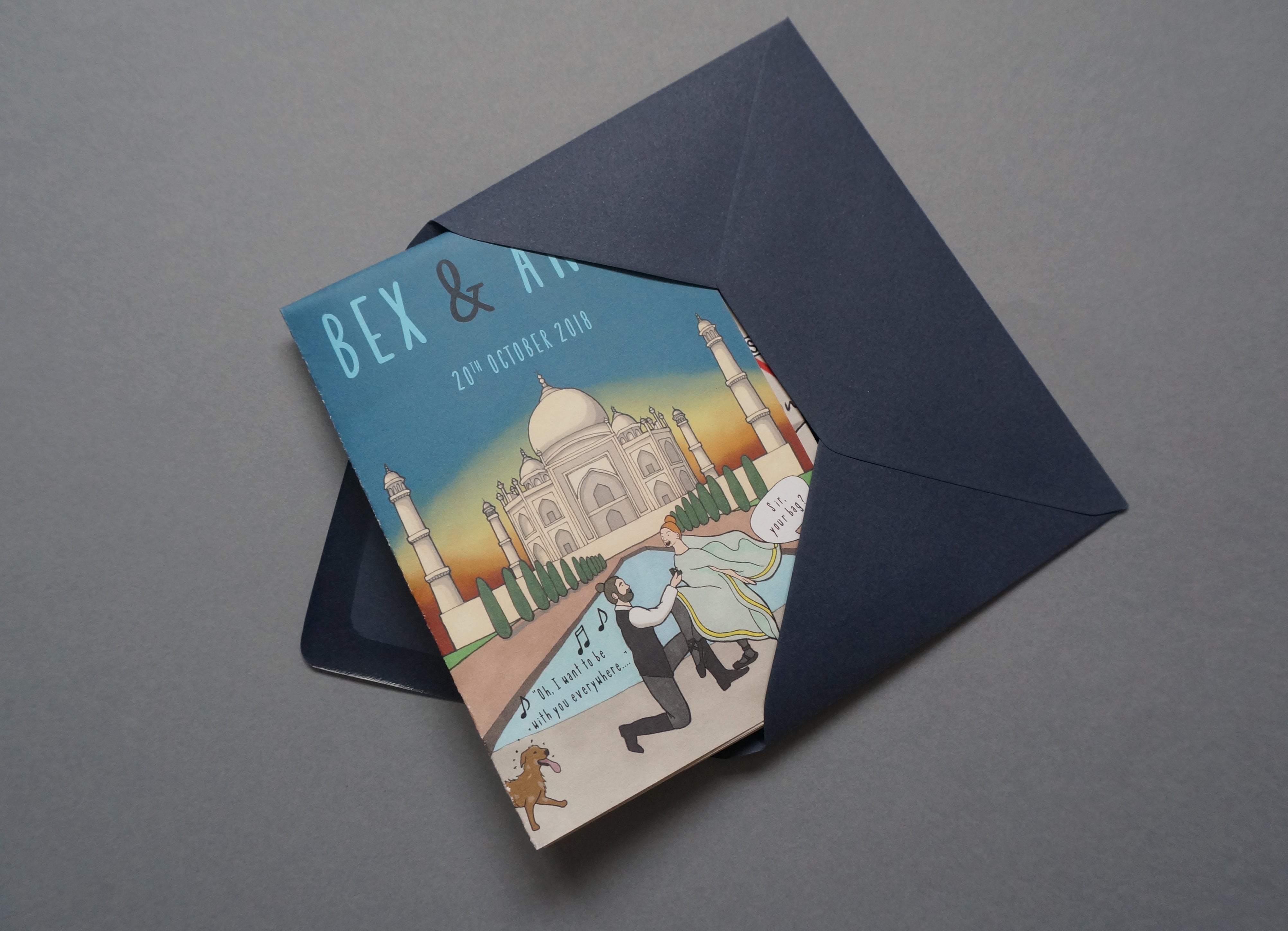 Wedding invitation in a dark blue envelope, with an alternative couple portrait.