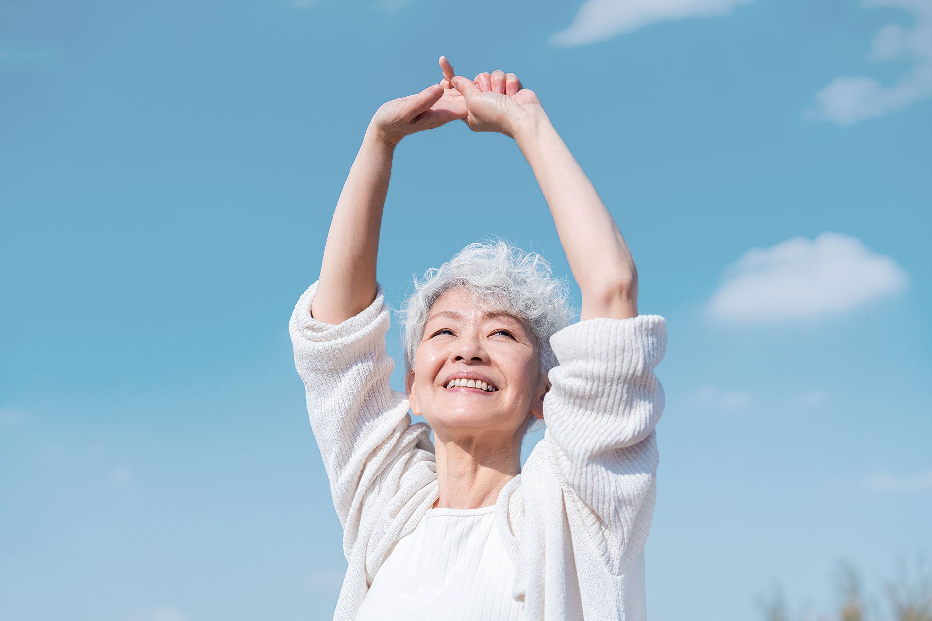 healthy energised elderly stretching under the sun