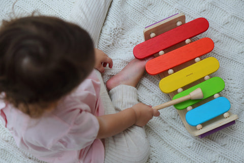 Child playing with xylophone