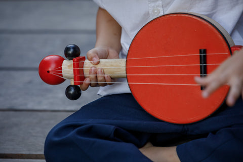 Child playing with banjo