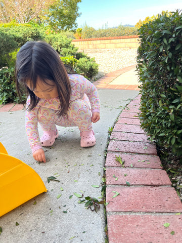 Child playing with leaves outside