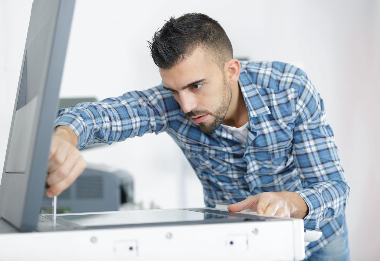 Base Technologies employee repairing a printer.
