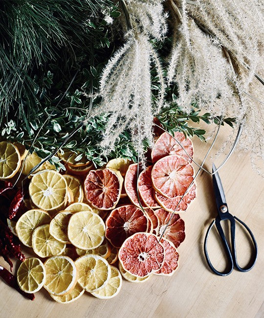 Christmas wreath with a modern twist. By adding dried orange slices and tree branches.