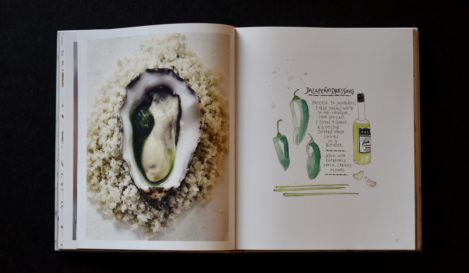 Open recipe book on miso soup, right side picture of an oyster left side recipe with an illustration of a jalapeño.. 