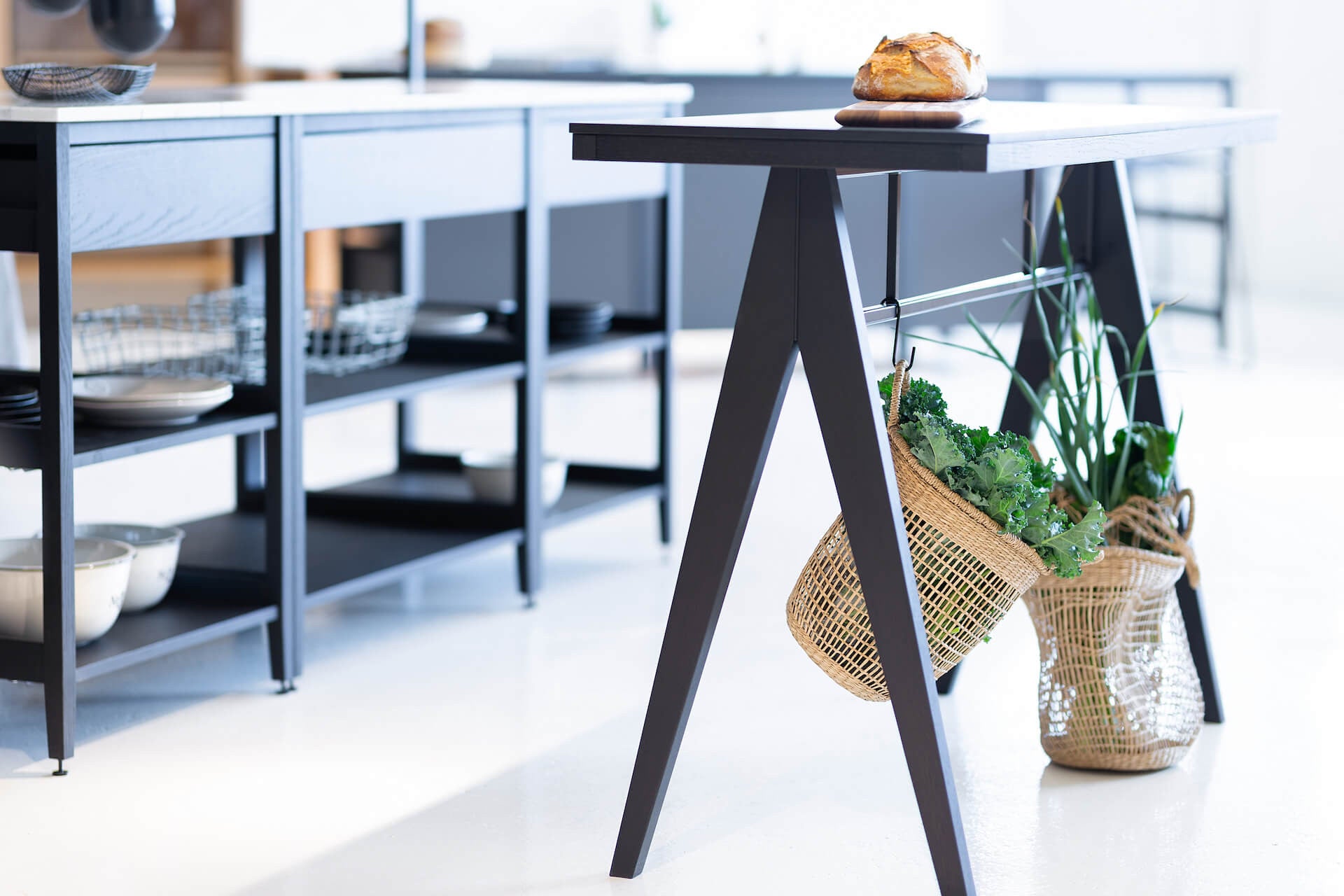 Coquo modular kitchen cabinets. Our braccas island in black stained oak with a metal bar, perfect to hang herbs. 