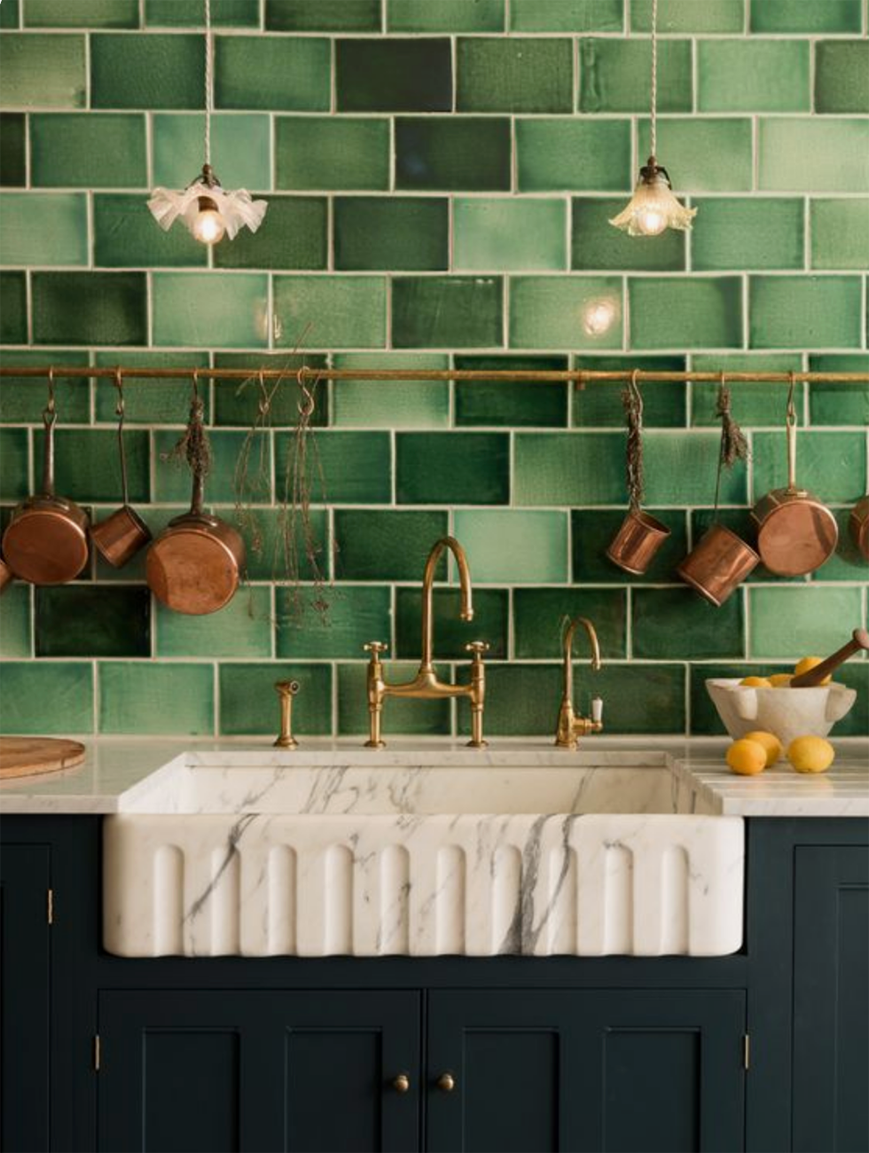Classic dark green lacquer kitchen with light green tile backsplash. Small brass details as handles and custom marble sink..