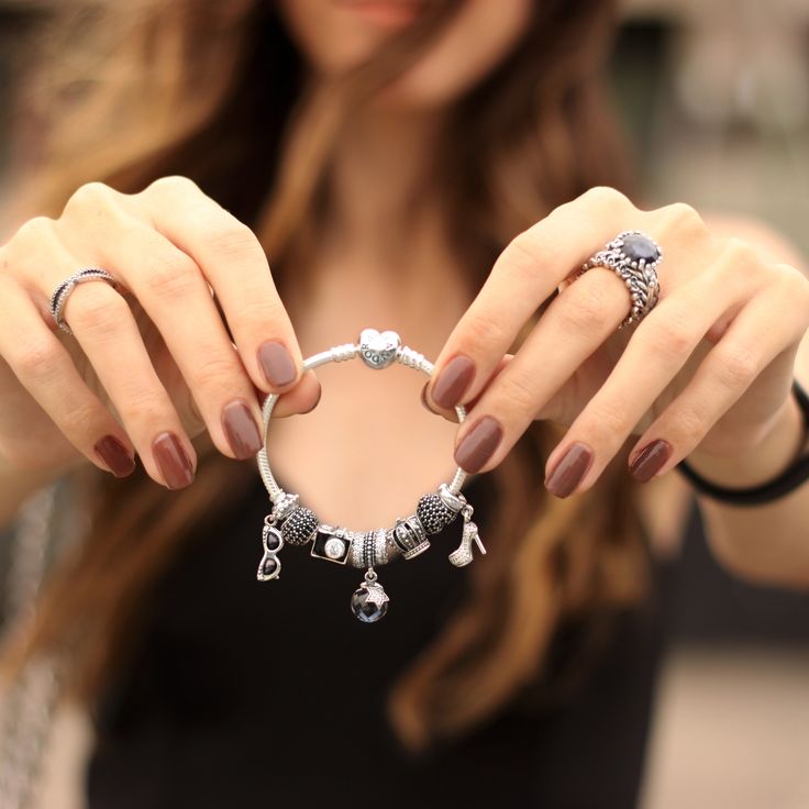 a woman holding a pair of rings