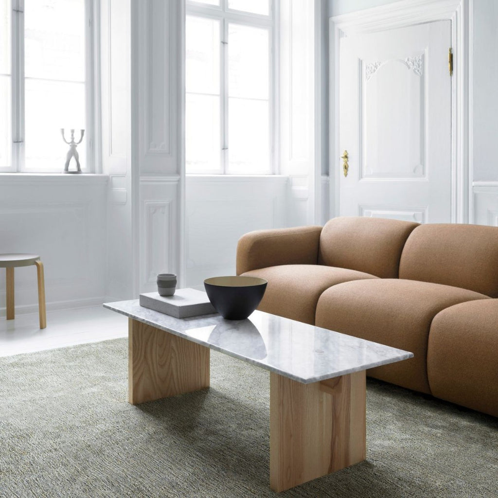 coffee table with a brown couch next to it