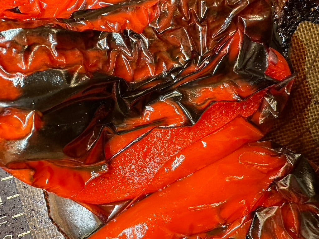 Oven roasted red bell peppers with blackened, blistered skin