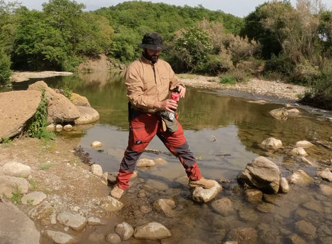 paolo di backpacco beve con la water-to-go dal fiume Mignone durante un corso di sopravvivenza