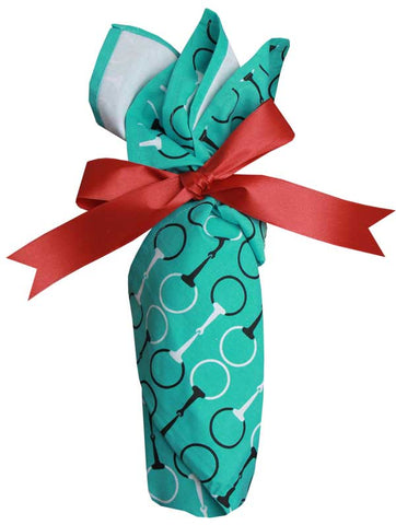 A wine bottle wrapped in a tea towel with ribbon 