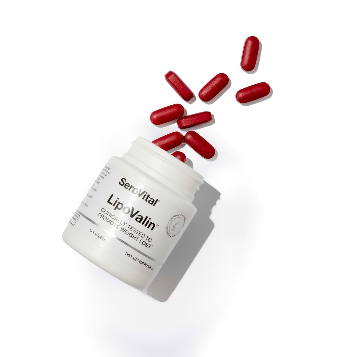 A bottle of LipoValin weight-loss supplement with red tablets spilling out the top.