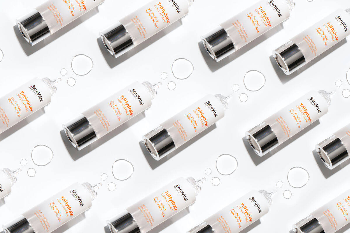 Bottles of TriHydrate lying on a white background with serum bubbles