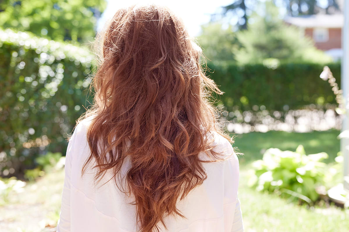 Woman with long, thick, gorgeous red hair falling down her back