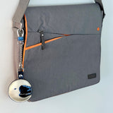 The Keeper leather moon design on a canvas messenger bag