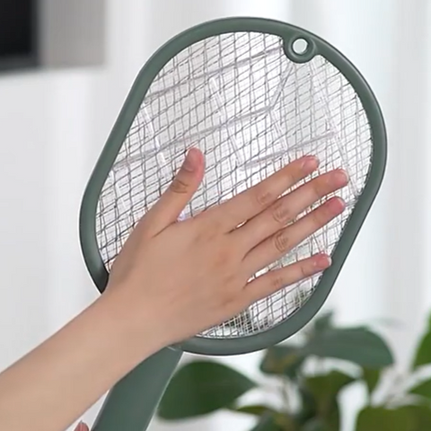 Electric swatter with hand making contact without getting shocked 