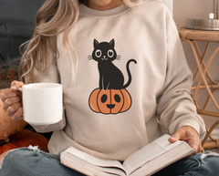 sand color sweatshirt with a vampire cat sitting on pumpkin