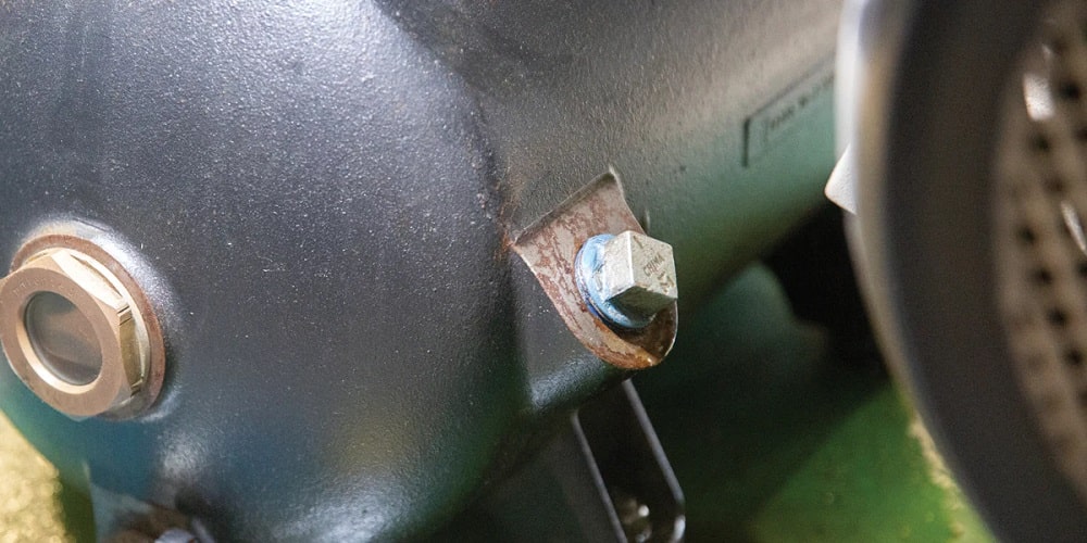 Closeup of oil sampling port on an industrial air compressor