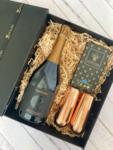 Black gift box filled with Australian sparkling wine, Australian chocolate and copper champagne flutes