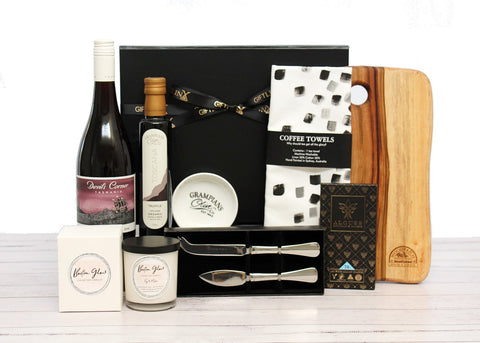 Corporate gift box filled with Australian wine, timber cheese board, chocolate and other premium Australian produce