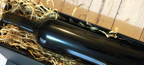 Clean skin wine bottle inside a black gift box