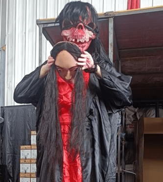 ghost animatronic removing her face while screaming, horror Halloween prop