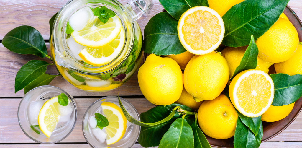 Yellow lemons in bowl, lemon water