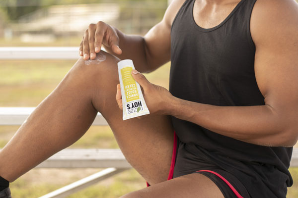 Man using Arnica Boost anti-inflammatory cream on knee
