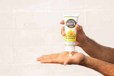 Man using Arnica Boost cream on dry hands