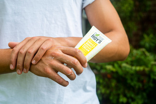 Person applying arnica cream to hands