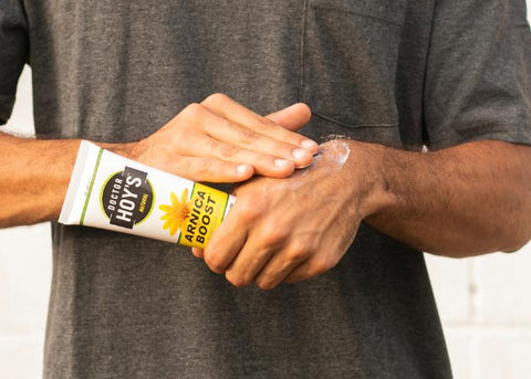 Man applying Doctor Hoy's Arnica Boost Cream