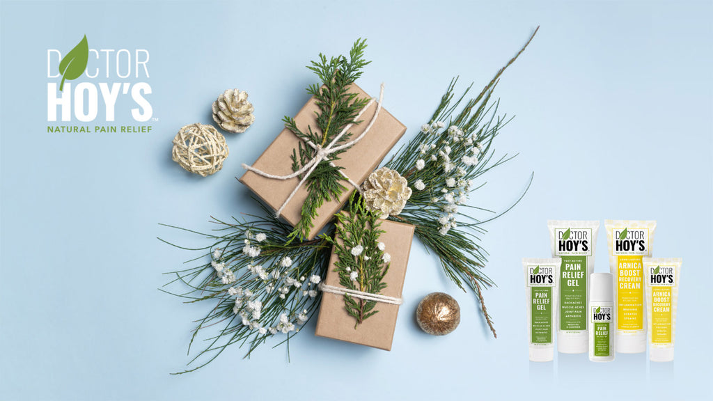 Pine nettles and paper wrapped Christmas gifts with natural topicals