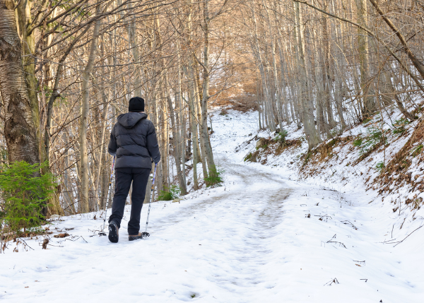 Person hiking on a trail in snow