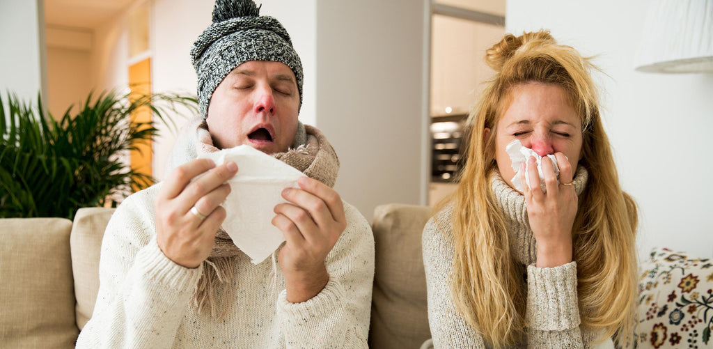 Man and woman suffering from a cold, irritated runny noses