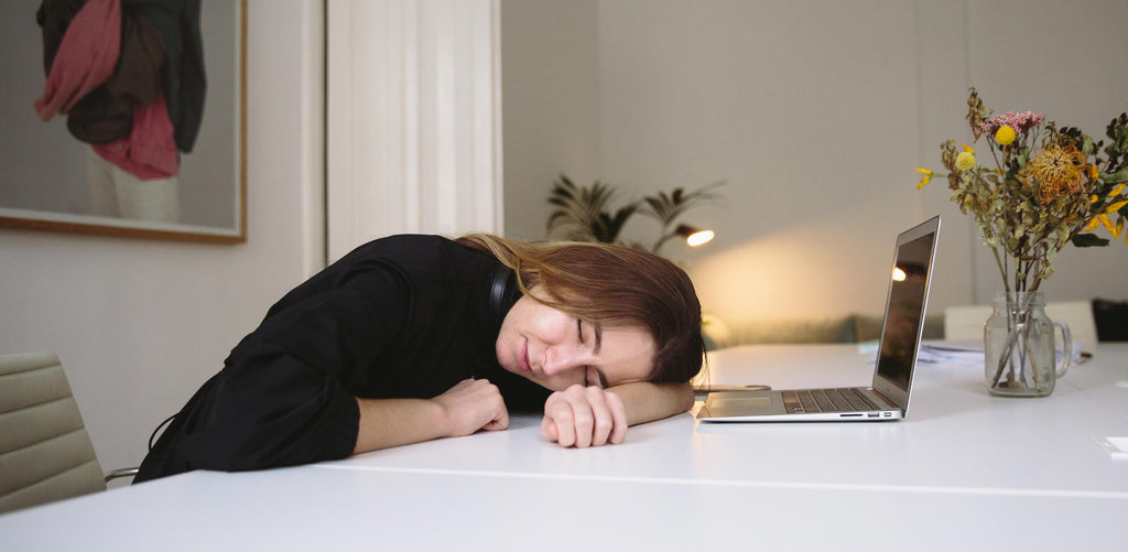 Woman falling asleep at desk because of sleep deprivation
