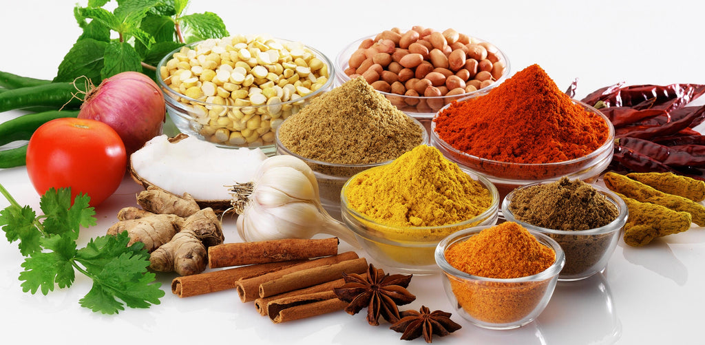 Spices, fruits, and vegetables; tomatoes, onions, peppers, coconut, chickpeas, garlic, ginger, cinnamon, oregano