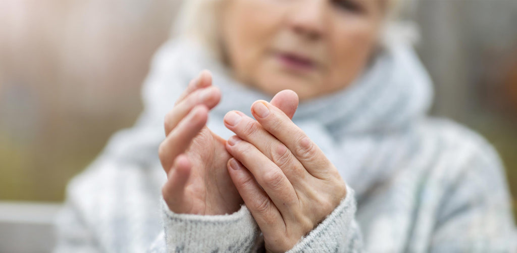 Woman struggling with pain in her hands from arthritis