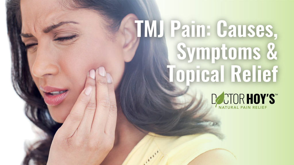 Woman with TMJ pain pressing hand to jaw