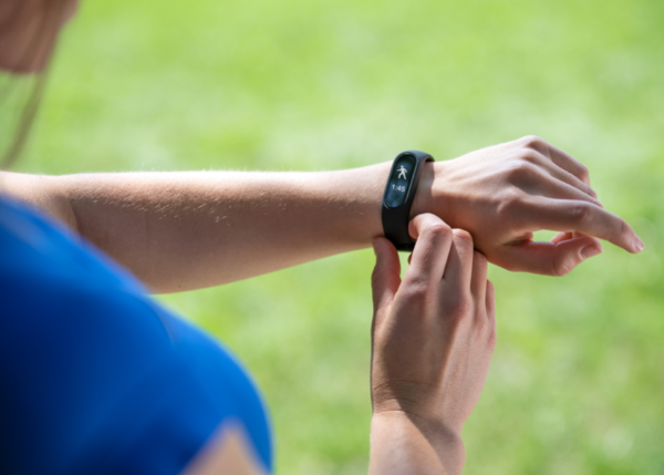 Woman checking a fitness tracker on her wrist