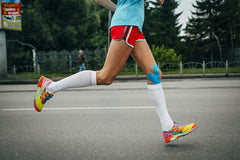Doctor Hoy's Blog Post Benefits of Combining Therapy Tape with Pain Relief Gel, Person Running with KT Tape