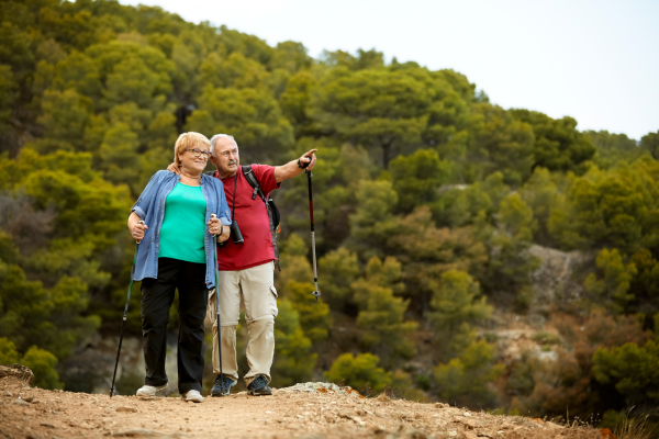 Elderly couple hiking with trekking poles