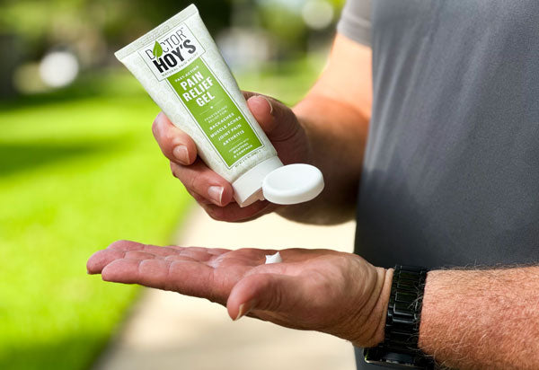 man applying arthritis pain relief gel to hand